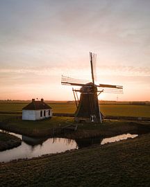 Holländische Mühle bei Sonnenuntergang in einer Polderlandschaft von Ewold Kooistra