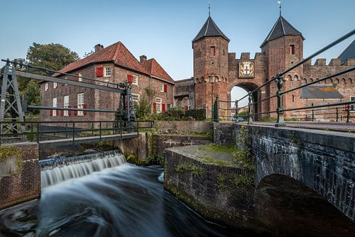 The Koppelpoort in Amersfoort in the evening with the lock in the foreground.