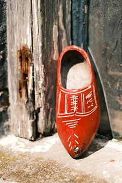 Elburg red clog in weathered window | Netherlands | Street photography