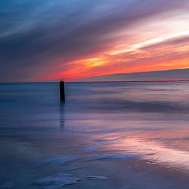 Sunset beach post on the beach. by Rob Baken