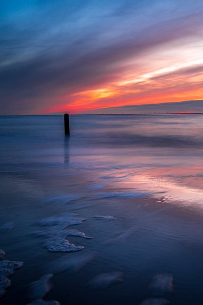 Sunset beach post on the beach. by Rob Baken