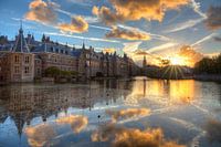 Dutch Houses of Parliament ( Binnenhof ) reflected in the Court pond during sunset