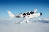 Cirrus SR20 airplane above the clouds