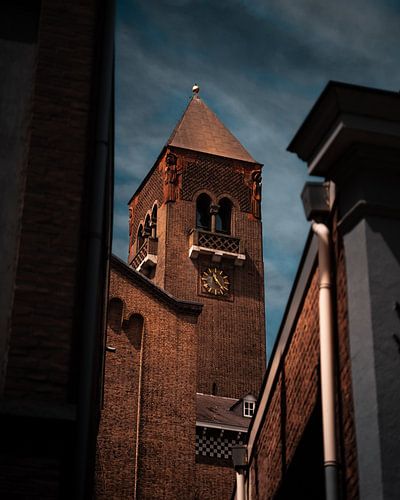 Church tower between buildings