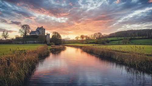 Historic castle on a river meadow