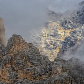 A play between the sun and the clouds, above the mountains of the Dolomites by Leon Okkenburg
