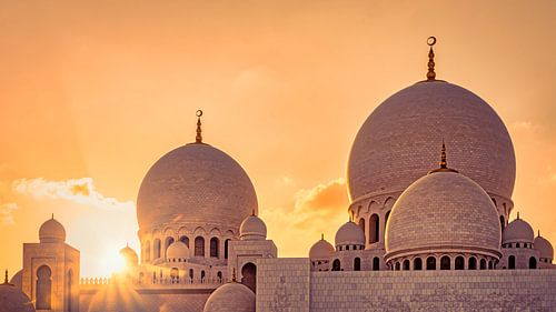 Domes of Sheikh Zayid Mosque at sunset in Abu Dhabi UAE