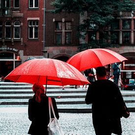 Red umbrellas in Amsterdam by Rutger van Loo