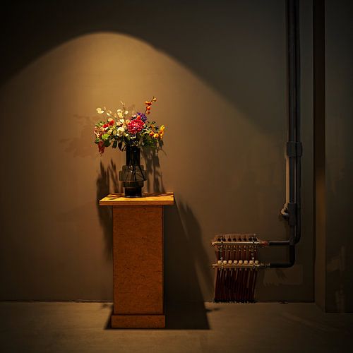 Vase of colorful flowers in old factory hall