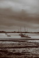 pleasure boats at low tide in sepia