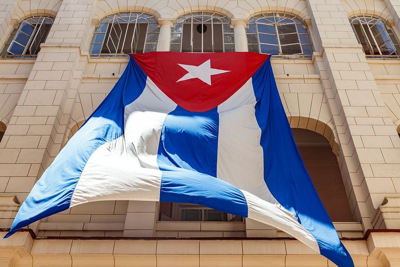 Large Cuban flag hangs in the patio of the Revolution Museum in Havana, Cuba by WorldWidePhotoWeb