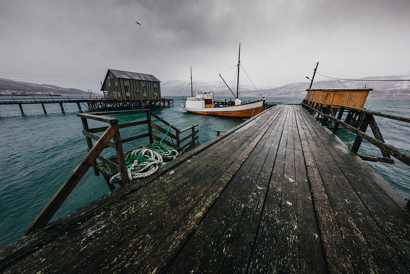 Wooden dock with boat by Martijn Smeets