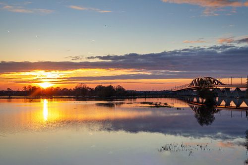 Railway bridge in Zwolle with setting sun. by Janny Beimers