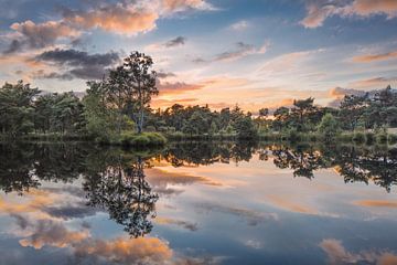 lac tranquille au coucher du soleil avec des nuages ​​étonnants sur Tony Vingerhoets