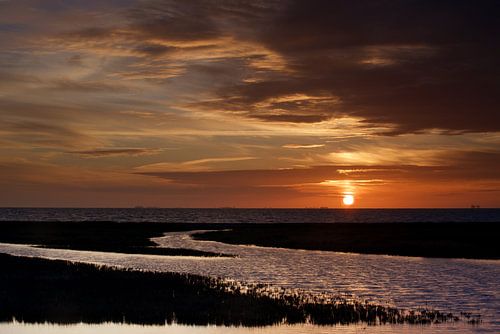 Colorful cloudy sky above the Wadden Sea at sunset