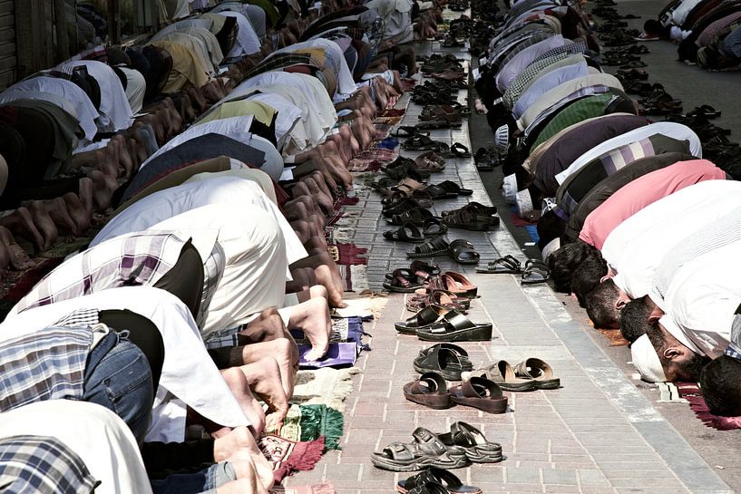 Muslims pray peacefully in Dubai during Friday prayers by Tjeerd Kruse
