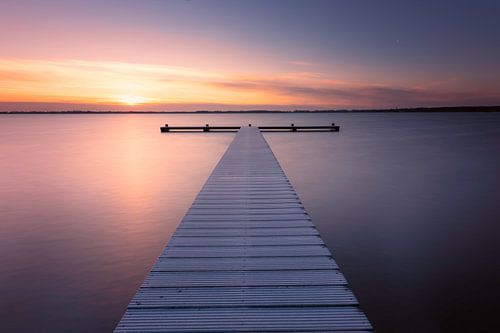Frozen jetty at Zuidlaardermeer at sunrise