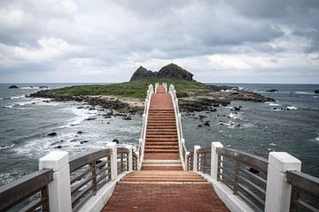 Stairs and bridge to a seaside island in Taiwan by Mickéle Godderis