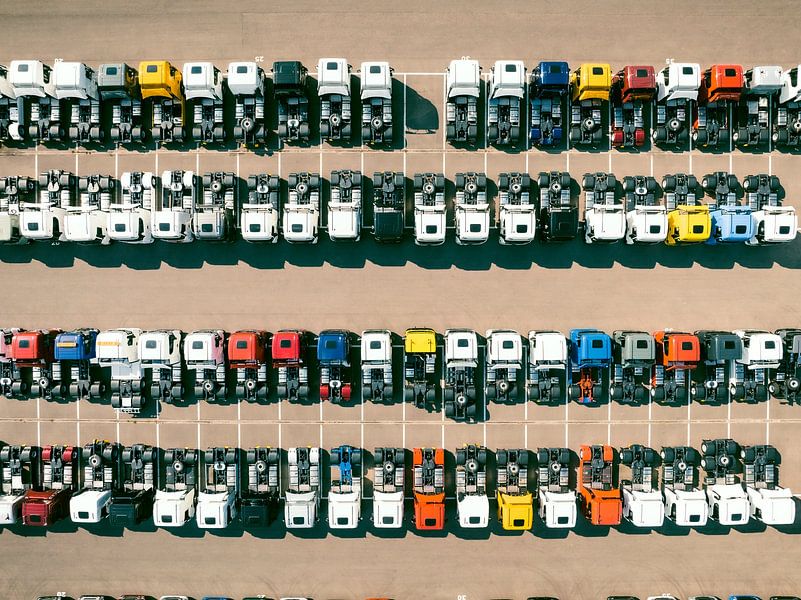 Trucks in a row at a parking lot seen from above by Sjoerd van der Wal Photography