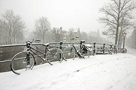 Cycling on the canal in snowy Amsterdam by Eye on You