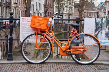 Oranje fiets aan brugleuning, Oude Gracht Utrecht van Ad Jekel