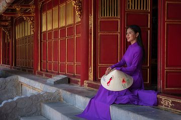 Vietnamese woman sits on the steps to the temple by Anges van der Logt
