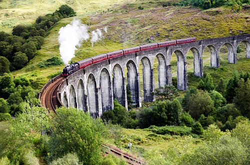 Jacobite steam train on old Glenfinnan viaduct in Scotland