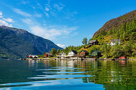 View of the Åkrafjord with wooden houses in Norway by Rico Ködder