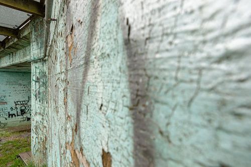 Weathered old concrete wall with peeling paint