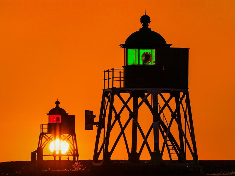 Stavoren lighthouses during sunset by Harrie Muis