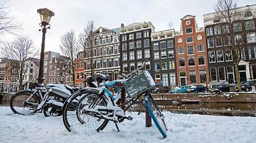 Besneeuwd Amsterdam op de grachten van Eye on You