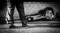 Tough roadie standing by lying guitar case