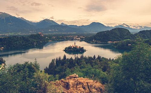 Panorama view over lake bled with island and church during sunset with the alps in the background, S