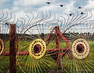 Rusty wheels against a fence! by Yvon van der Wijk