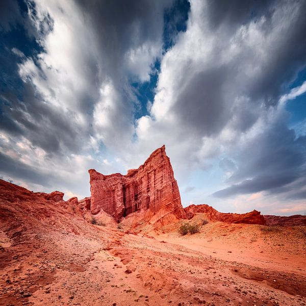Red rock formations under an angry cloud cover by Chris Stenger