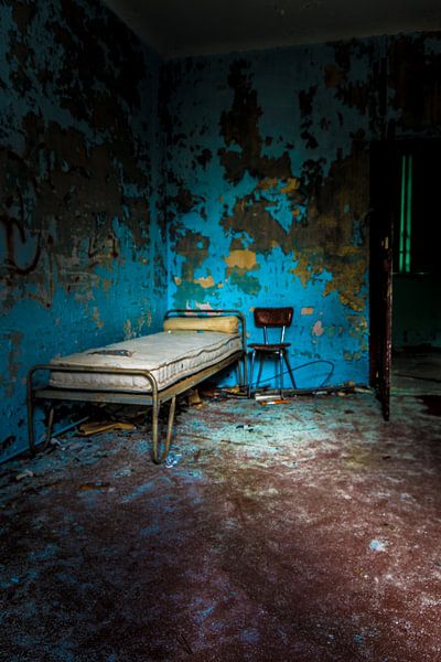 Old bed and chair in an abandoned orphanage in France by Elly de Vries