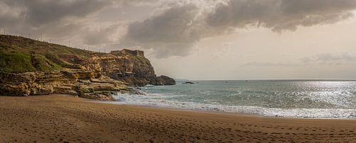 Sandy beach with cliffs and gentle waves