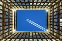 Hamburg courtyard with a plane in the sky