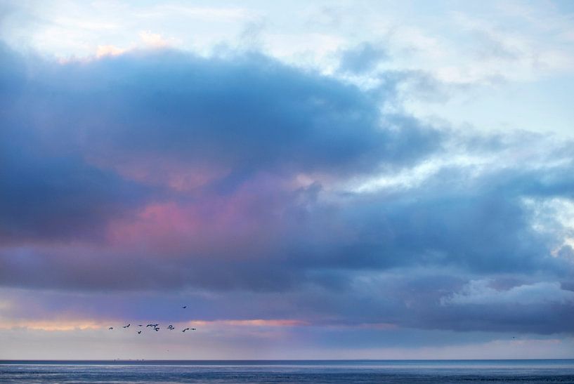 Clouds over Wadden Sea near Westhoek during low tide by Marcel van Kammen