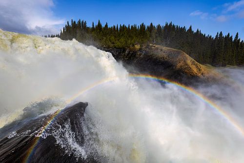 Rainbow at the roaring waterfall