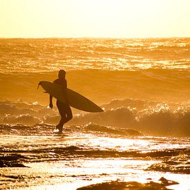 Surfer runs into the surf, Kalbarri, Australia