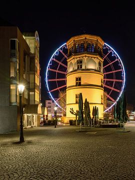 Castle tower in Dusseldorf and red ferris wheel van Michael Valjak