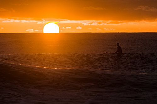 Surfing at sunrise