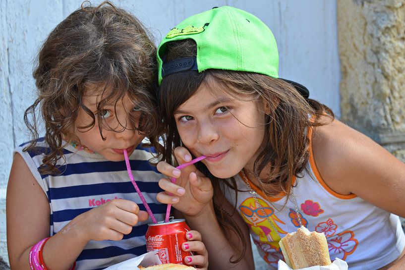 Twee meisjes op een markt in Saint Emilion in Frankrijk. van Wim Aalbers