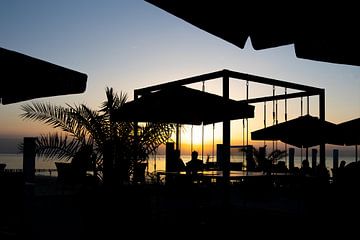 on a seaside terrace at sunset by Ria van den Broeke