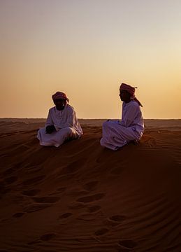 Two chatting men in the desert at sunset by Lisette van Leeuwen