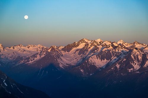 Sunset over snowy mountain peaks in the alps