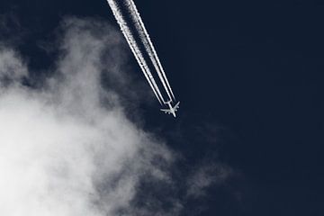 Airplane contrails in blue sky by Thomas Marx