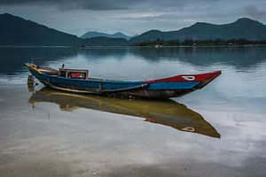 Fishing boat with reflection in the water. by Adri Vollenhouw