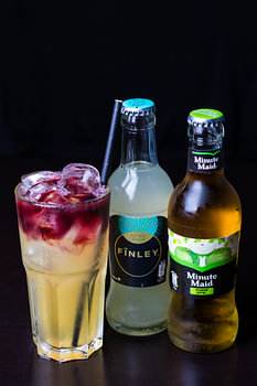 Cocktail made with Passoa against a black background
